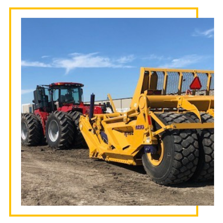 a large tractor parked in the dirt